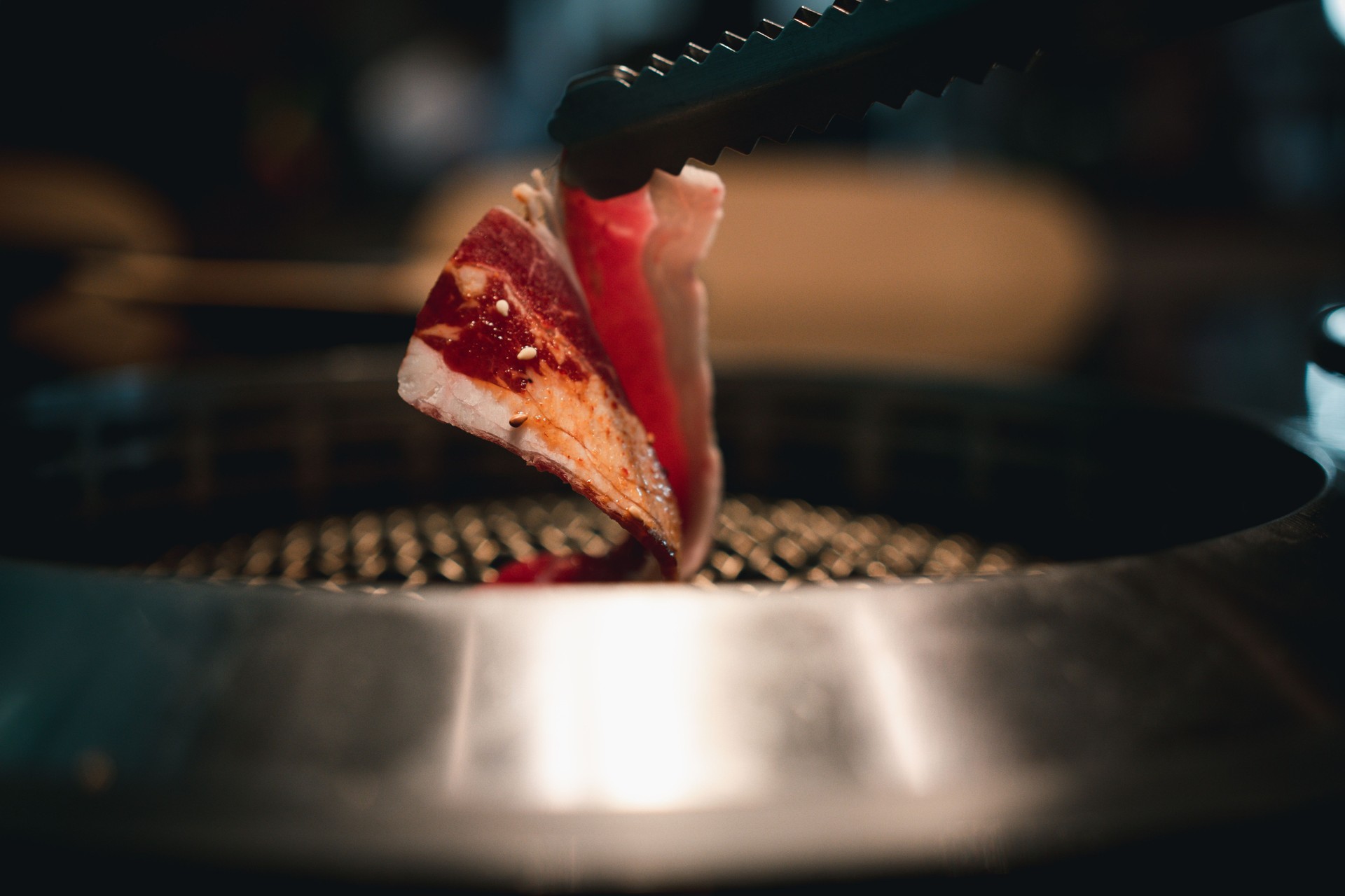 Grill beef with tongs