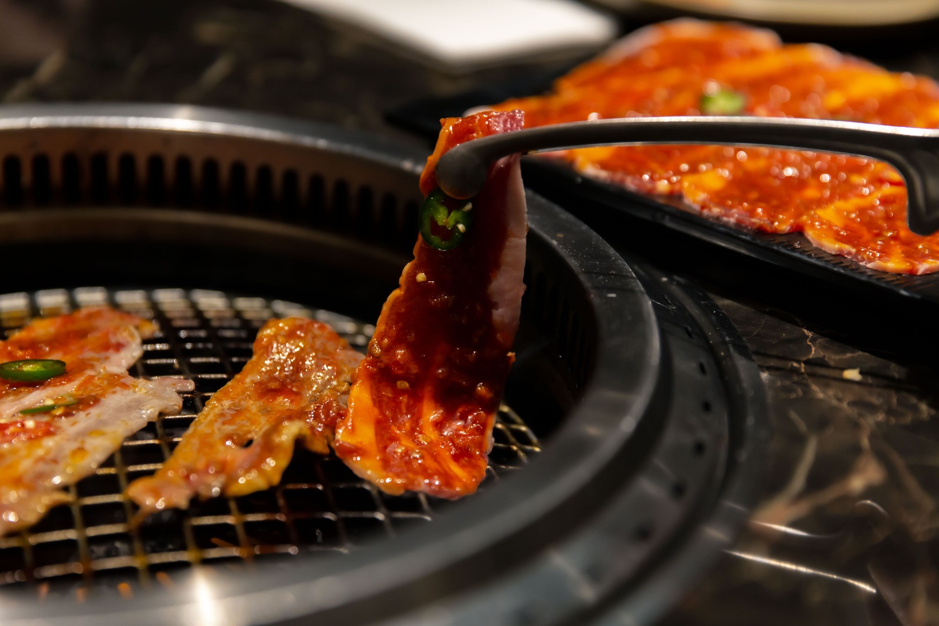 Marinated Wagyu Beef Sizzling on the Grilled Plate at a Korean BBQ Restaurant